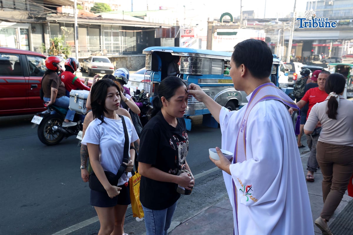 (February 18 2026) Kamuning First Methodist Church Administrative Pastor Randi Jay Austria waits along Kamuning Road in Quezon City for passersby and motorists wanting ash on their forehead during the observance of Ash Wednesday February 18 2026. Photo/Analy Labor