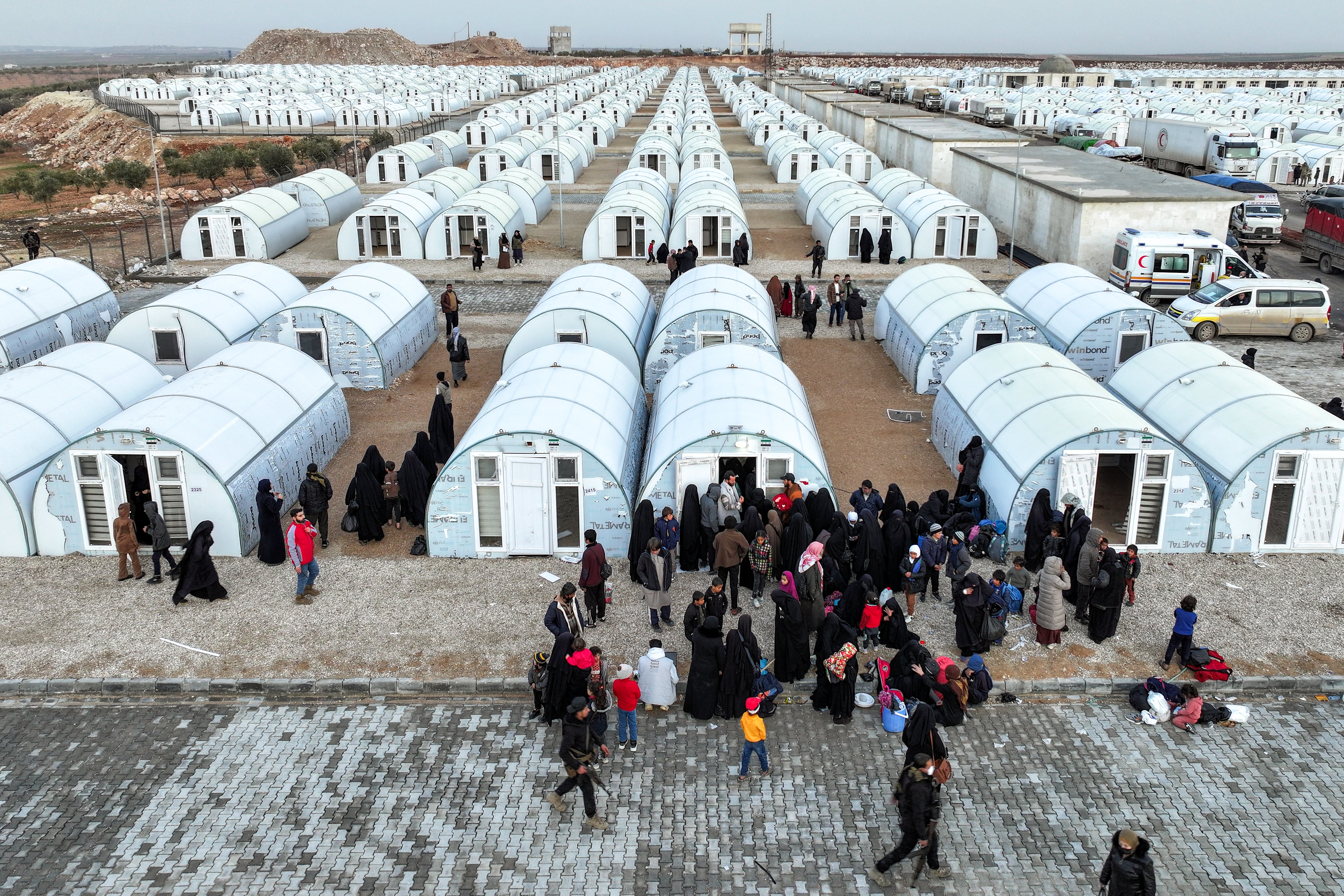 PEOPLE arrive from the Al-Hol camp in eastern Syria by the new tent shelters at the Akbaran camp near Akhtarin, in the north of Aleppo province, on 17 February 2026. Syria began evacuating remaining residents of Al-Hol camp, which long housed relatives of suspected Islamic State group fighters, as it empties the formerly Kurdish-controlled facility, two officials told Agence France-Presse. Al-Hol was taken over by government forces from its Kurdish administrators.