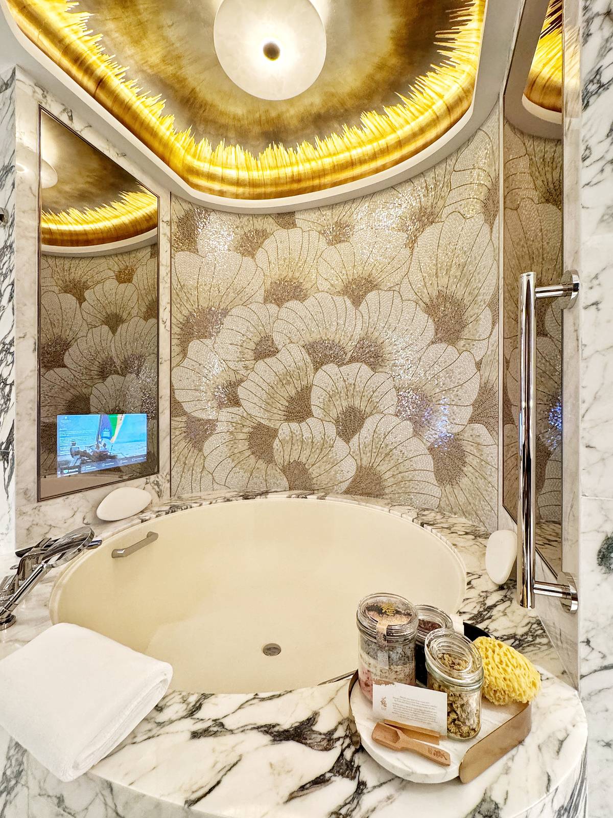 THE suite’s round marble bathtub is framed by magnolia mosaics and features the hotel’s signature bath salts from YUN Wellness.