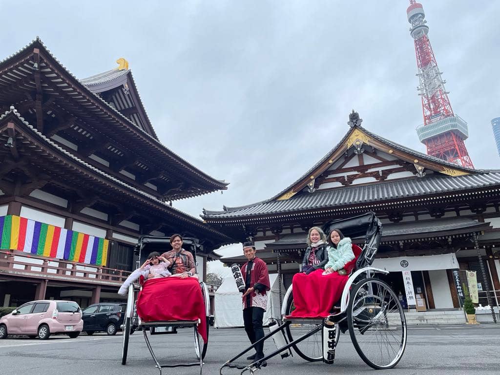 RIDING traditional human-pulled rickshaw with a photo-op in front Zojoji Temple and Tokyo Tower.