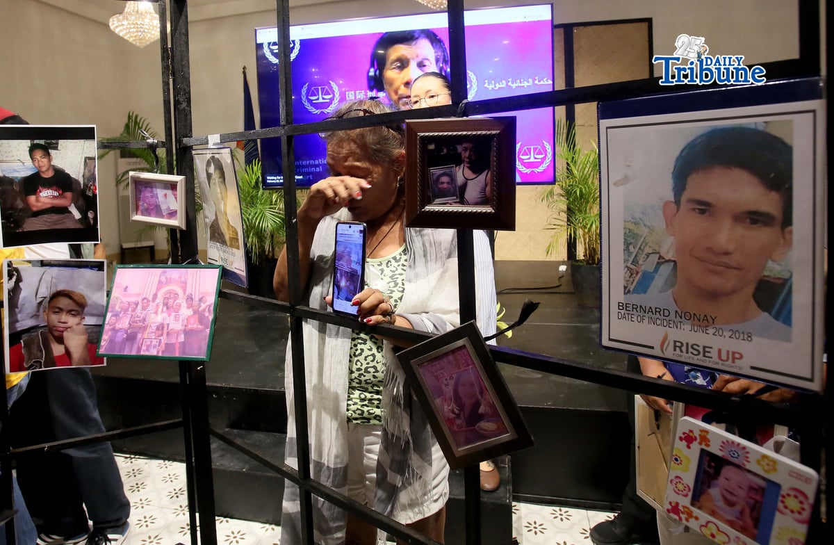 (February 23 2026) Families of the alleged EJK victims carrying the photos of their late loved ones, during the  International Criminal Court (ICC)  confirmation of charges hearing against former President Rodrigo Duterte, in his crimes against humanity case linked to the government’s anti-drug campaign, held at atencio Libunao hall in University of Philippine, diliman Quezon City, on Monday February 23 2026. Photo/Analy Labor