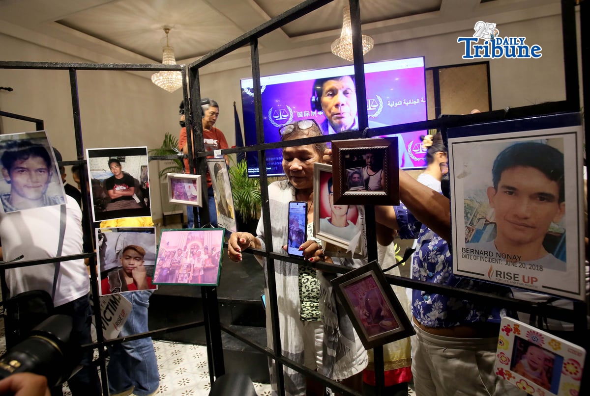 (February 23 2026) Families of the alleged EJK victims carrying the photos of their late loved ones, during the  International Criminal Court (ICC)  confirmation of charges hearing against former President Rodrigo Duterte, in his crimes against humanity case linked to the government’s anti-drug campaign, held at atencio Libunao hall in University of Philippine, diliman Quezon City, on Monday February 23 2026. Photo/Analy Labor