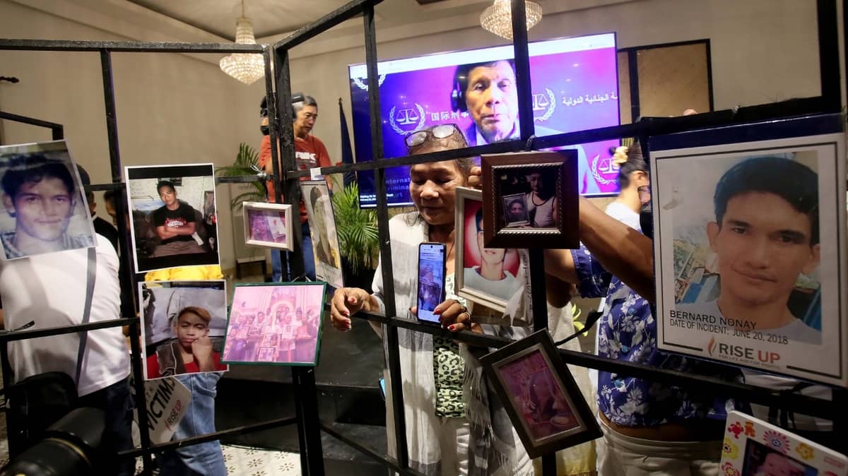 FAMILIES of alleged extrajudicial killing victims hold photos of their late loved ones during the International Criminal Court confirmation of charges hearing against former President Rodrigo Duterte over crimes linked to the government’s anti-drug campaign. The event was held at Atencio Libunao Hall, University of the Philippines Diliman, Quezon City, on Monday.