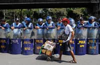Street vendor sells ice cream to police on duty at EDSA 40