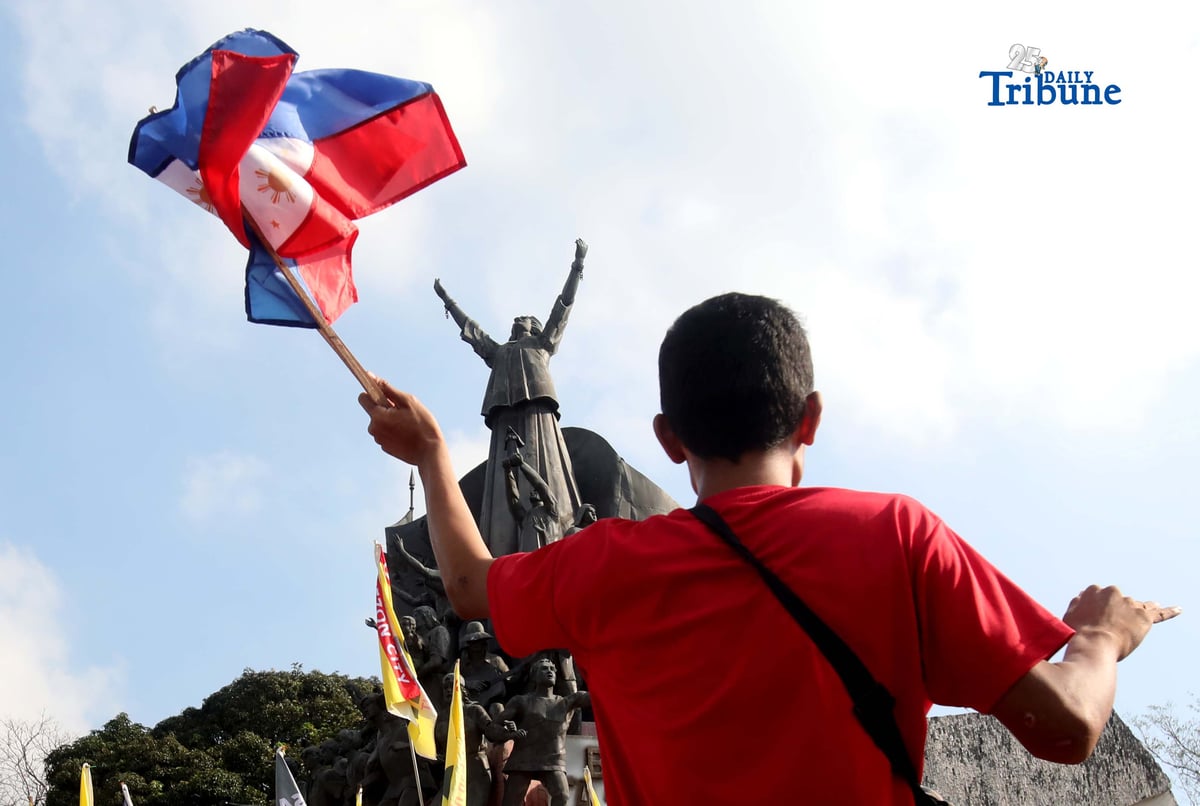 (February 25 2026) A young Man waving Philippine flag at the People Power Monument, during the 40th people power anniversary celebration along Edsa in Quezon City, on Wednesday February 25 2026. Photo/Analy Labor