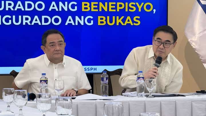 SSS President and CEO Robert Joseph de Claro (left) and DOF Secretary Frederick Go speak at a press conference at the SSS headquarters in Quezon City on Thursday, 26 February.