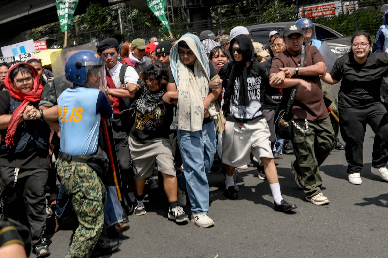 People continue to push through amid police using force via shields in an effort to stop protesters from progressing to the iconic National Shrine of Mary, Queen of Peace--commonly known as EDSA Shrine.