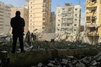 A man looks at the damage at the site of an Israeli airstrike that targeted the Al Lailaki neighbourhood in Beirut’s southern suburbs on March 4, 2026. Israel launched fresh strikes on Iran and Lebanon, where state media reported a residential building was hit on March 4, as Iran's Guards said they had sealed off one of the world's most vital shipping routes for energy.