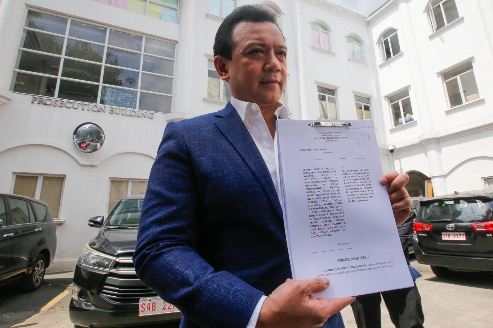 Former Senator Antonio Trillanes IV arrives at the Department of Justice in Manila on  05 March 2026, to file cyberlibel and perjury complaints against lawyer Levi Baligod and 18 "ex-marines." The complaints stem from allegations of a bribery scheme involving ICC investigators. Also named in the filing are Mike Defensor, Jay Sonza, Lorraine Badoy, and Cathy Binag for their alleged roles in spreading the claims.
