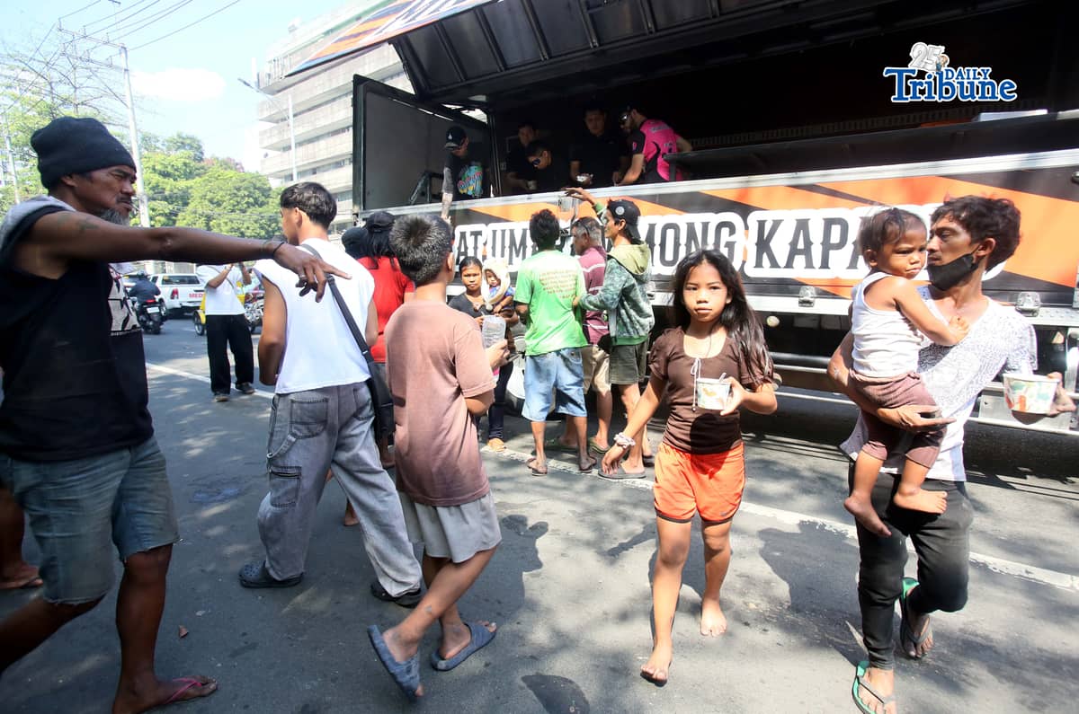GOOD Samaritans distributed free porridge, or lugaw, to fire victims after a blaze that reached Task Force Bravo level gutted numerous houses in Barangay Pinyahan, Quezon City, on Saturday, 07 March 2026.