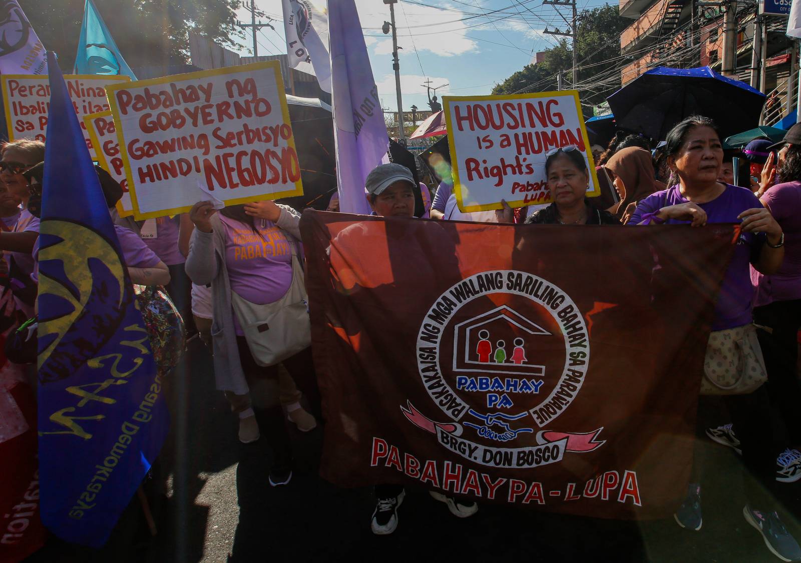 Women's rights advocates gather at Mendiola, Manila, on Saturday morning, ahead of International Women's Day, to call for decent housing for all, an end to corruption, and the demilitarization of rural areas.