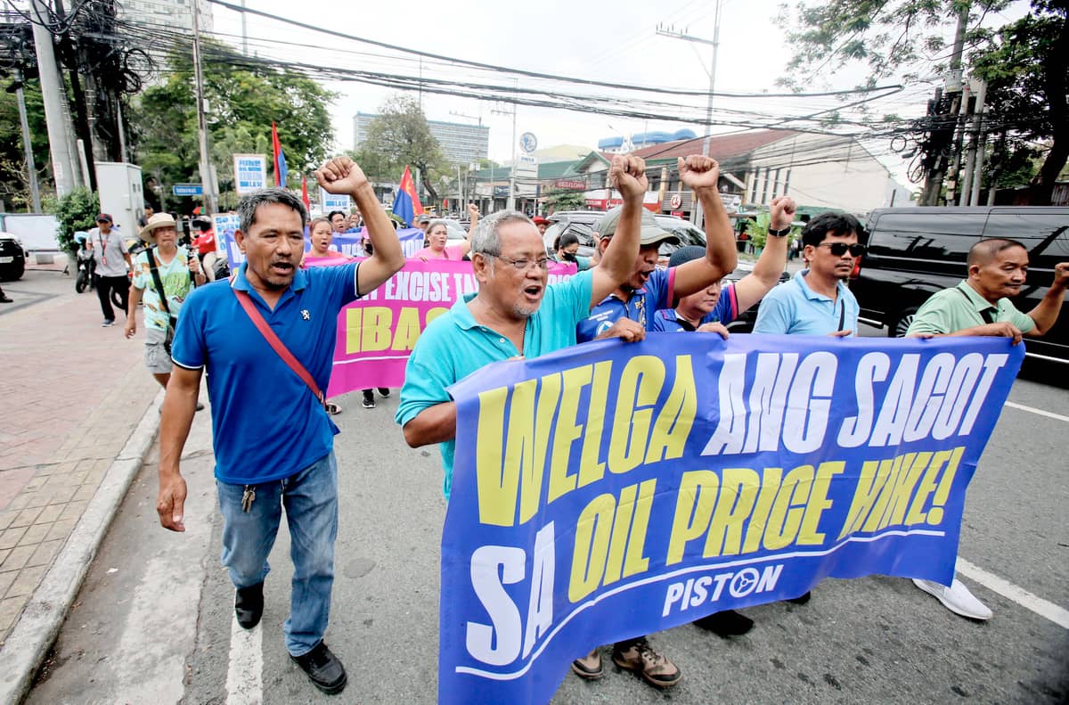 MEMBERS of transport group PISTON stage a protest in front of a gas station along East Avenue in Quezon City on Monday, calling on the government to remove the value-added tax and excise tax on fuel products ahead of an impending big-time oil price hike.