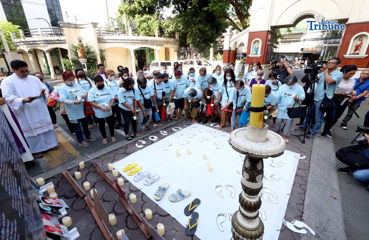 (March 11 2026) Families of EJK victims during the Duterte administration offer flowers and prayers for their departed loved ones along with photos, to mark the first anniversary of the arrest of former President Rodrigo Duterte by the International Criminal Court on Wednesday, March 11, 2026, at Sacred Heart Parish in Quezon City. Photo/Analy Labor