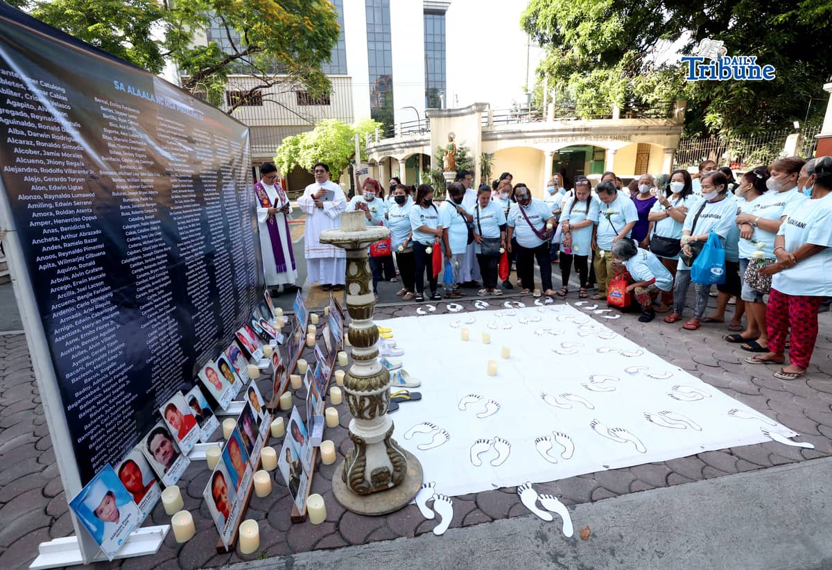 (March 11 2026) Families of EJK victims during the Duterte administration offer flowers and prayers for their departed loved ones along with photos, to mark the first anniversary of the arrest of former President Rodrigo Duterte by the International Criminal Court on Wednesday, March 11, 2026, at Sacred Heart Parish in Quezon City. Photo/Analy Labor