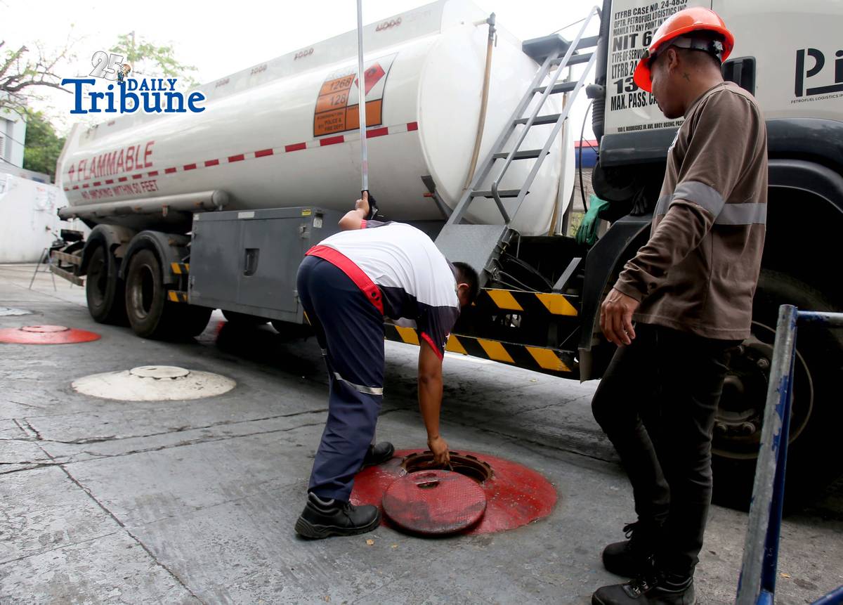 (March 11 2026) Gas attendants measure the fuel  supply in their tanks at a gasoline station along East Avenue in Quezon City on Tuesday March 10 2026, following the hike in prices by oil companies due to the on-going conflict in the Middle East. Photo/Analy Labor