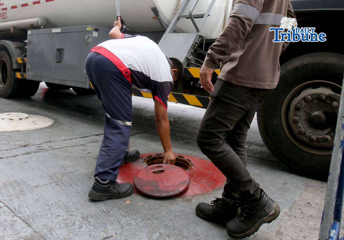 (March 11 2026) Gas attendants measure the fuel  supply in their tanks at a gasoline station along East Avenue in Quezon City on Tuesday March 10 2026, following the hike in prices by oil companies due to the on-going conflict in the Middle East. Photo/Analy Labor