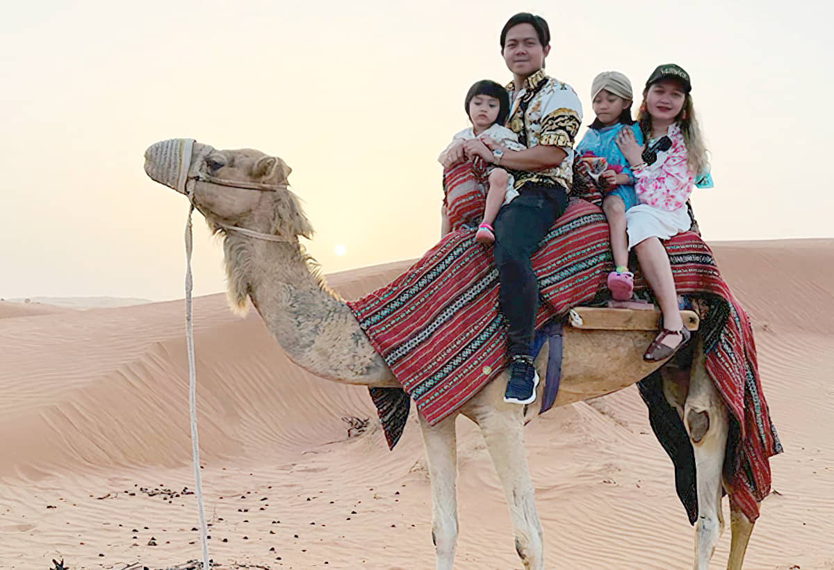 THE columnist wearing a Fendace hat, one of Donatella Versace’s last designs as Versace creative director, during a camel ride with family in Ras Al Khaimah.