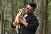 A PET owner holds his dog in a park, reflecting the close bond between Filipinos and their pets as Maxicare launches its PRIMA Animal Bite Care e-voucher aimed at providing accessible treatment and protection against animal bite incidents.