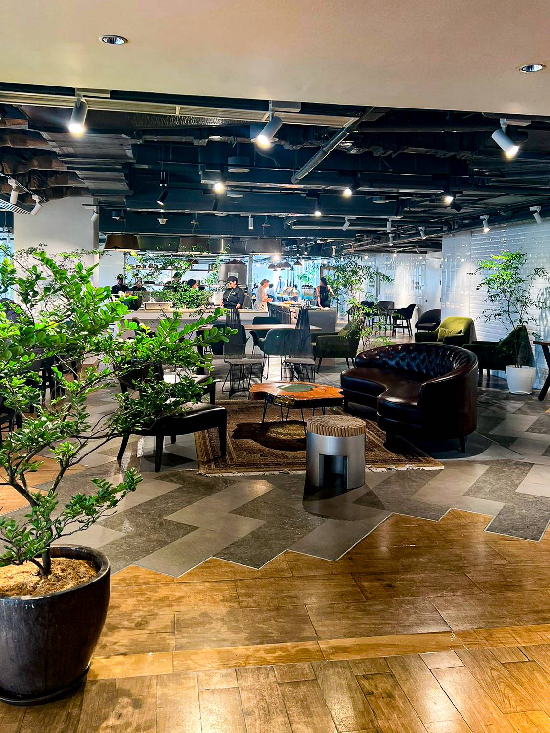 ORIGINE restaurant’s interior in Brittany Hotel BGC. The elegant and modern cushioned couches and chairs and space filled with plants provides a warm and cozy atmosphere to dine in.