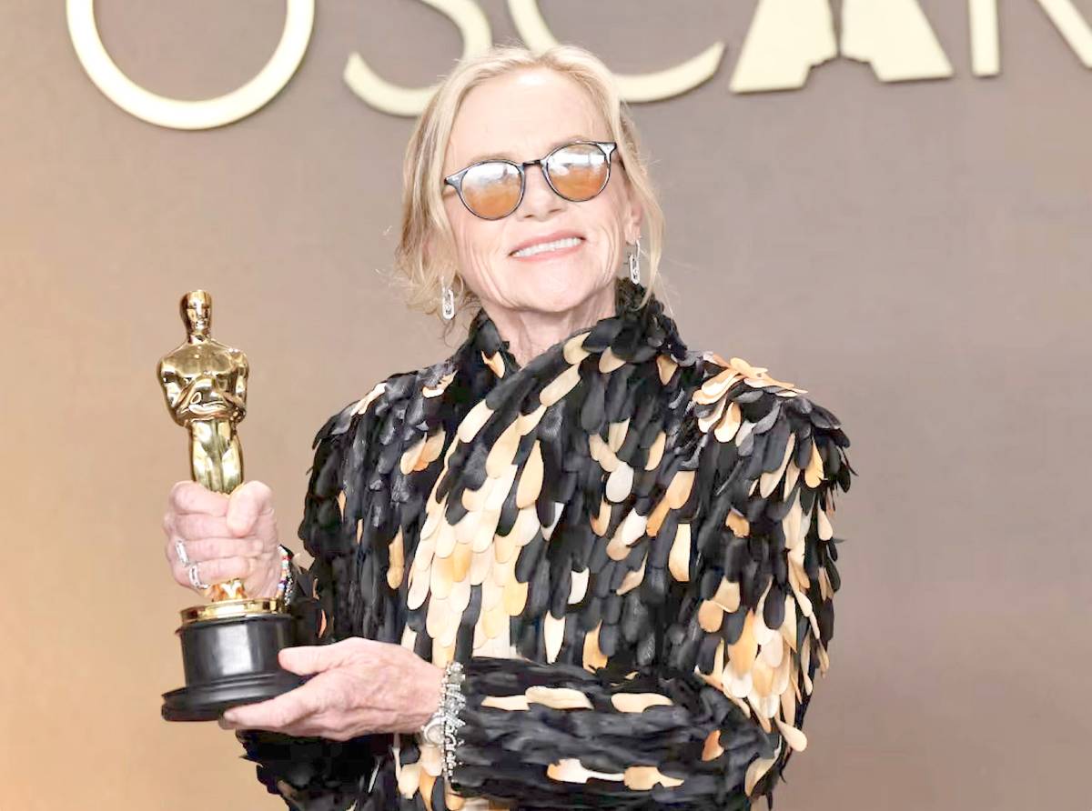 AMY Madigan is photographed holding her first Oscar trophy.