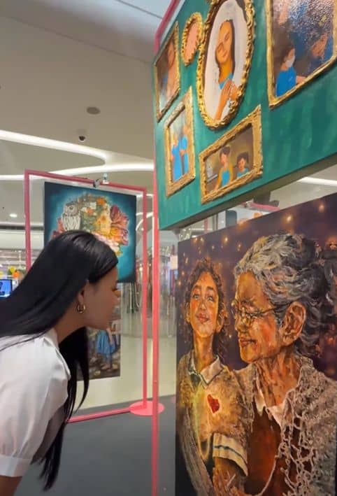 A VISITOR views one of the artworks on display during the Sining Filipina 2026 exhibit at The Podium.