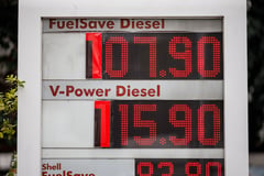 Gas stations use cardboard cutouts for their pricing displays as oil prices soar