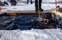 A PARTICIPANT in the Polar Scientific Diving program enters the water for a 45-minute-long diving session, at the Kilpisjaervi Biological Station in Finland on 14 March 2026.