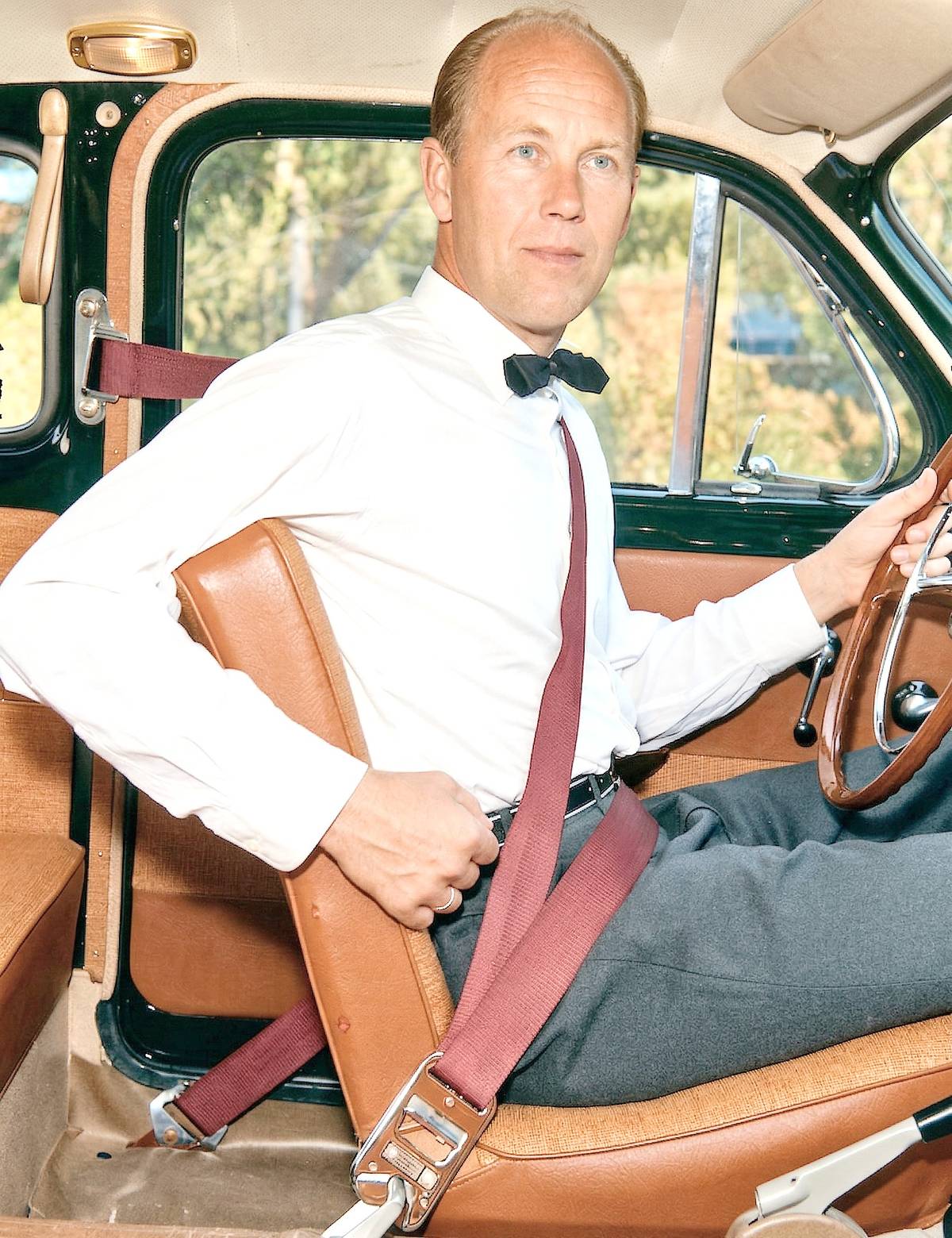 INVENTOR Nils Bohlin demonstrates the early three-point seatbelt that shaped modern vehicle safety.