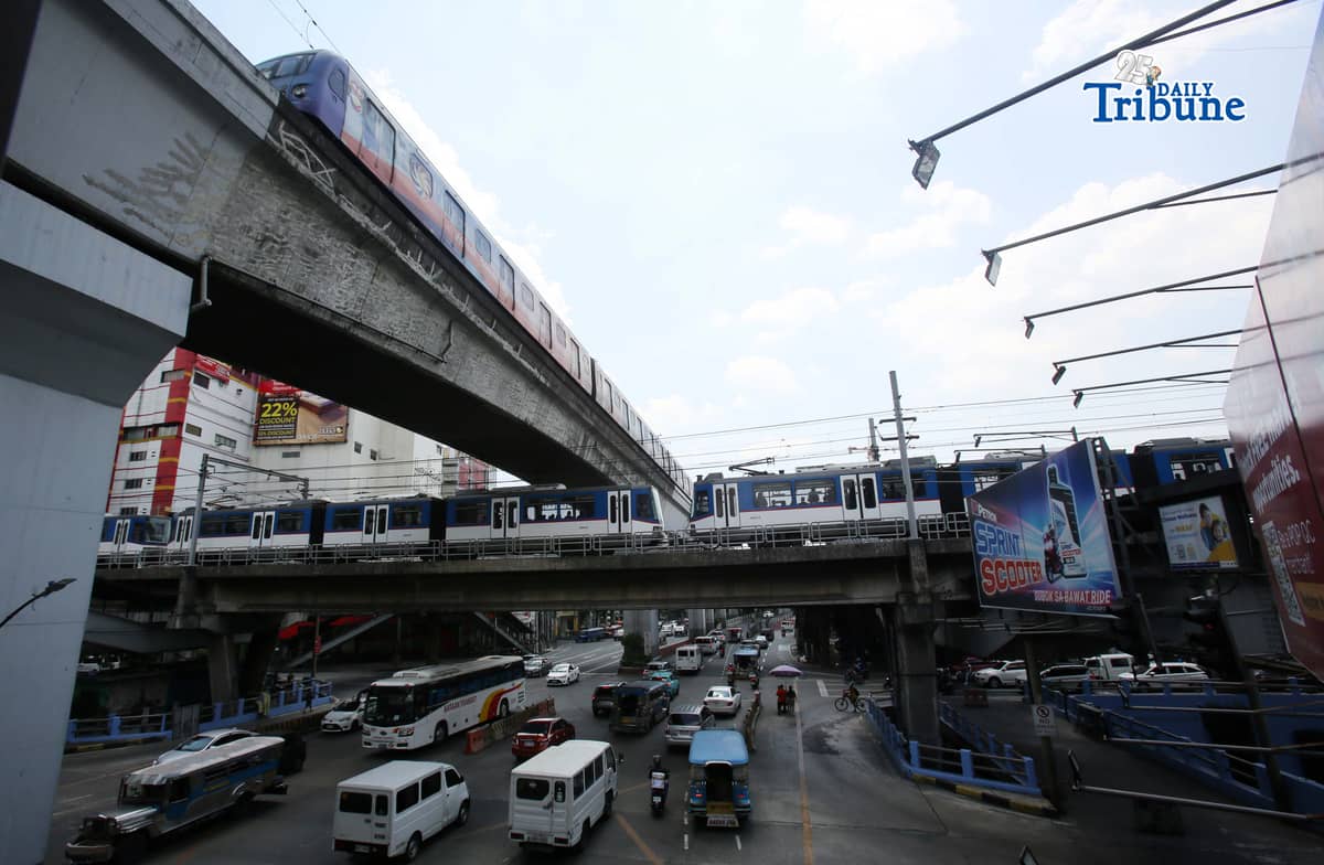 Trains of the Metro Rail Transit Line 3 and Light Rail Transit Line 2 run along tracks in Cubao, Quezon City, 23 March 2026, as a 50 percent fare discount takes effect to help ease the impact of rising fuel prices. The discount applies to all passengers, except those already entitled to reduced fares such as students, senior citizens, and persons with disabilities.