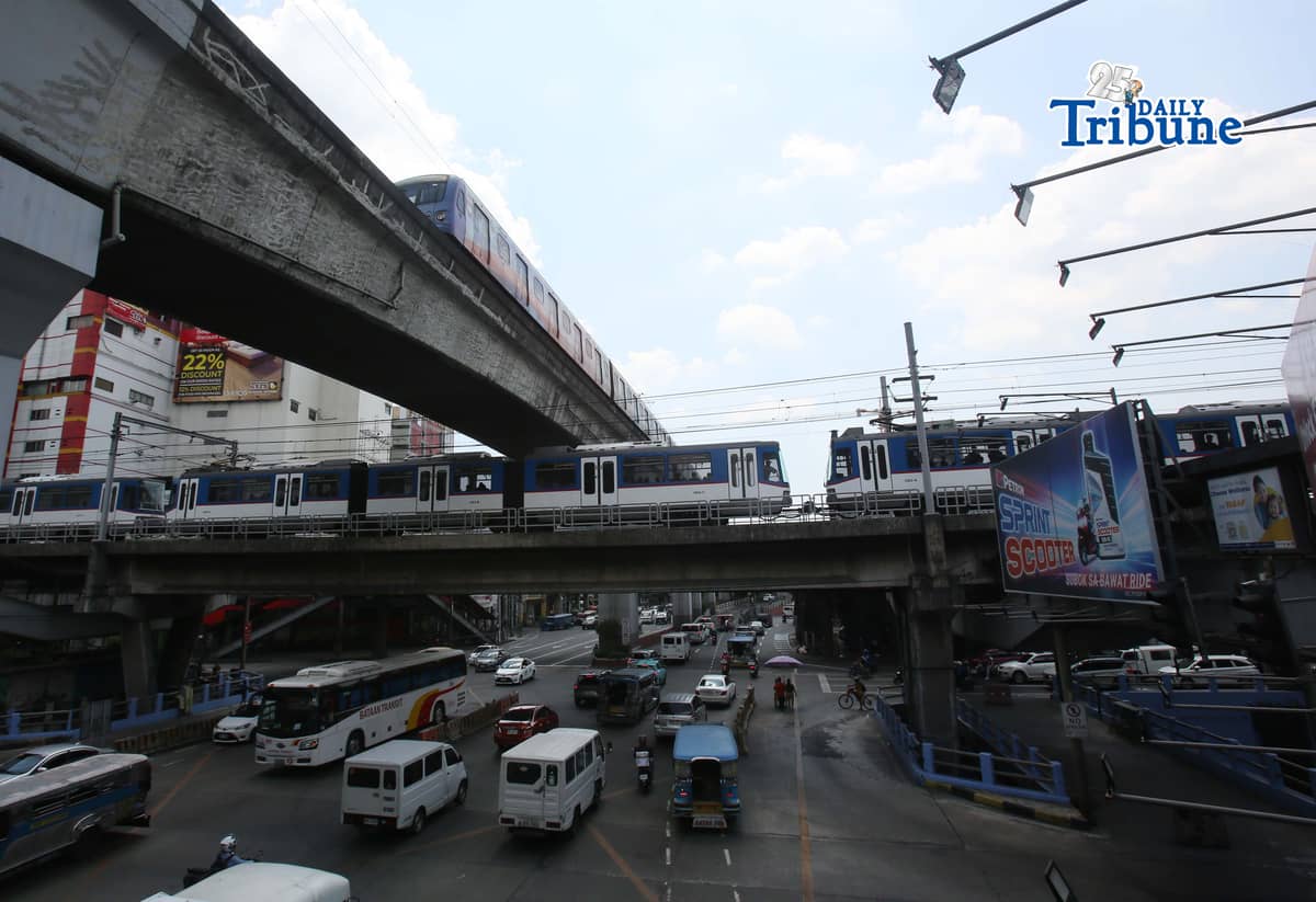 Trains of the Metro Rail Transit Line 3 and Light Rail Transit Line 2 run along tracks in Cubao, Quezon City, 23 March 2026, as a 50 percent fare discount takes effect to help ease the impact of rising fuel prices. The discount applies to all passengers, except those already entitled to reduced fares such as students, senior citizens, and persons with disabilities.