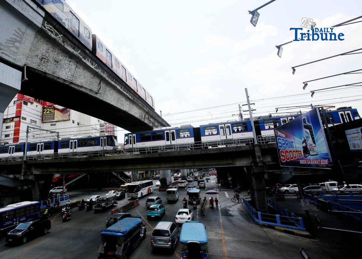 Trains of the Metro Rail Transit Line 3 and Light Rail Transit Line 2 run along tracks in Cubao, Quezon City, 23 March 2026, as a 50 percent fare discount takes effect to help ease the impact of rising fuel prices. The discount applies to all passengers, except those already entitled to reduced fares such as students, senior citizens, and persons with disabilities.