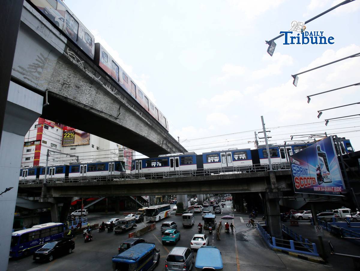 Trains of the Metro Rail Transit Line 3 and Light Rail Transit Line 2 run along tracks in Cubao, Quezon City, 23 March 2026, as a 50 percent fare discount takes effect to help ease the impact of rising fuel prices. The discount applies to all passengers, except those already entitled to reduced fares such as students, senior citizens, and persons with disabilities.