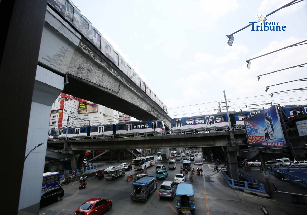 Trains of the Metro Rail Transit Line 3 and Light Rail Transit Line 2 run along tracks in Cubao, Quezon City, 23 March 2026, as a 50 percent fare discount takes effect to help ease the impact of rising fuel prices. The discount applies to all passengers, except those already entitled to reduced fares such as students, senior citizens, and persons with disabilities.
