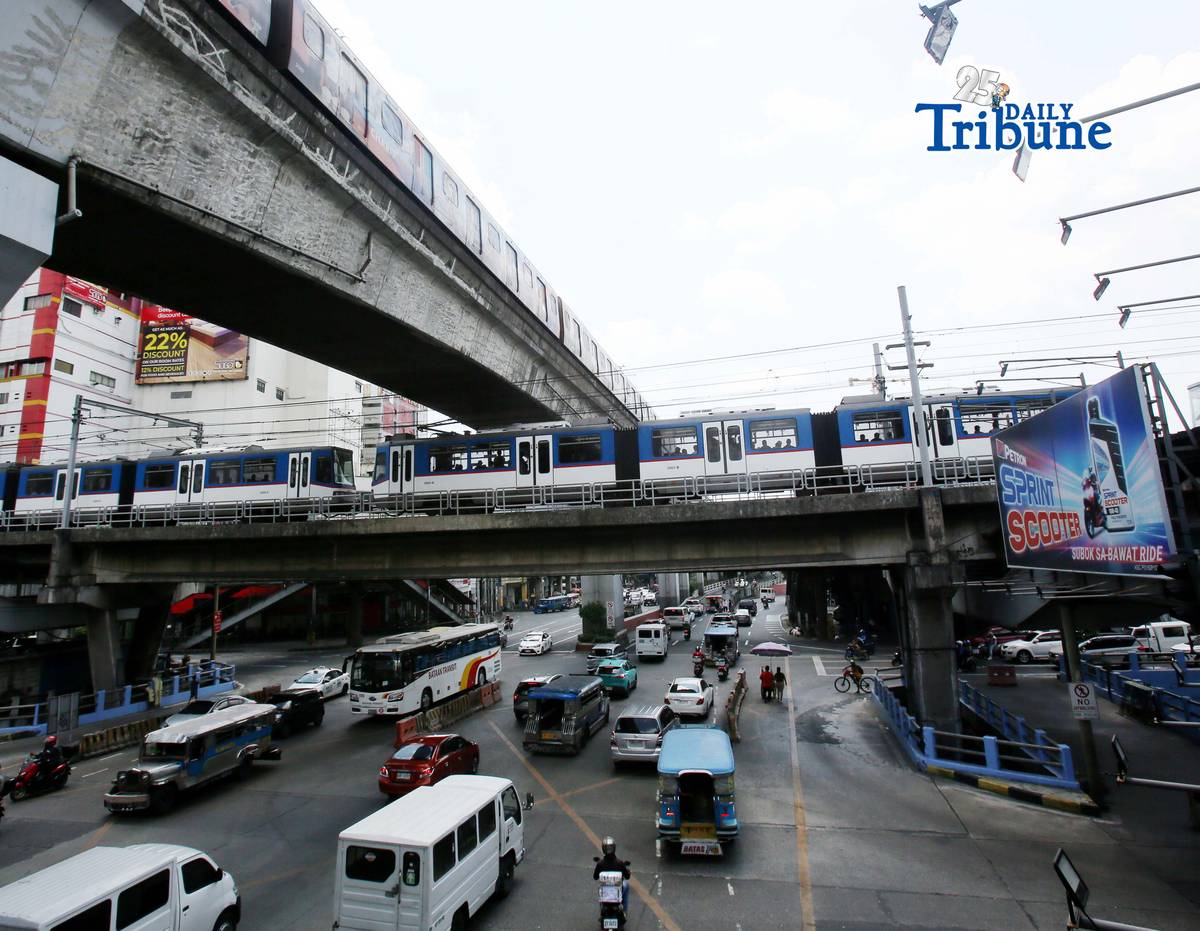 Trains of the Metro Rail Transit Line 3 and Light Rail Transit Line 2 run along tracks in Cubao, Quezon City, 23 March 2026, as a 50 percent fare discount takes effect to help ease the impact of rising fuel prices. The discount applies to all passengers, except those already entitled to reduced fares such as students, senior citizens, and persons with disabilities.