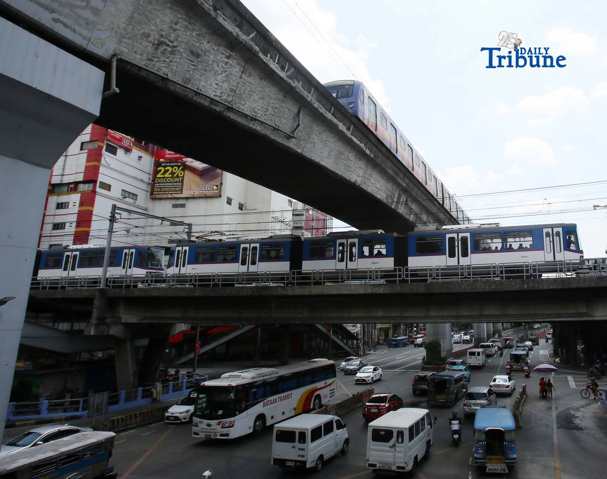 Trains of the Metro Rail Transit Line 3 and Light Rail Transit Line 2 run along tracks in Cubao, Quezon City, 23 March 2026, as a 50 percent fare discount takes effect to help ease the impact of rising fuel prices. The discount applies to all passengers, except those already entitled to reduced fares such as students, senior citizens, and persons with disabilities.
