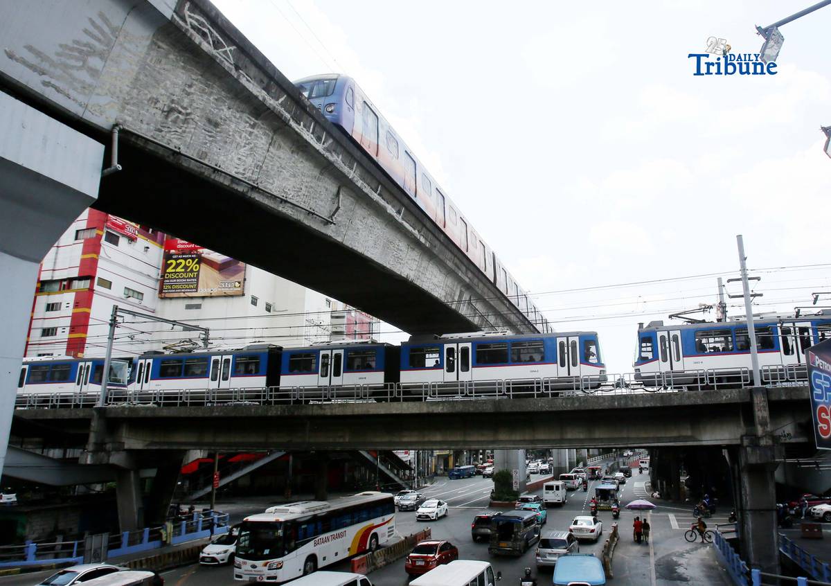 Trains of the Metro Rail Transit Line 3 and Light Rail Transit Line 2 run along tracks in Cubao, Quezon City, 23 March 2026, as a 50 percent fare discount takes effect to help ease the impact of rising fuel prices. The discount applies to all passengers, except those already entitled to reduced fares such as students, senior citizens, and persons with disabilities.