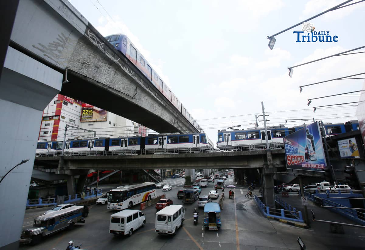 Trains of the Metro Rail Transit Line 3 and Light Rail Transit Line 2 run along tracks in Cubao, Quezon City, 23 March 2026, as a 50 percent fare discount takes effect to help ease the impact of rising fuel prices. The discount applies to all passengers, except those already entitled to reduced fares such as students, senior citizens, and persons with disabilities.