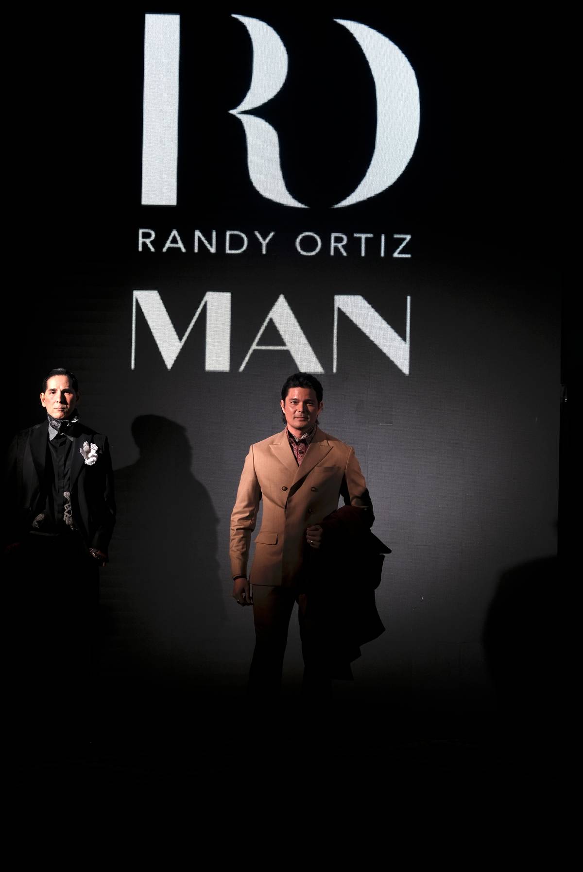 DINGDONG Dantes in a sleek double breasted tan suit.