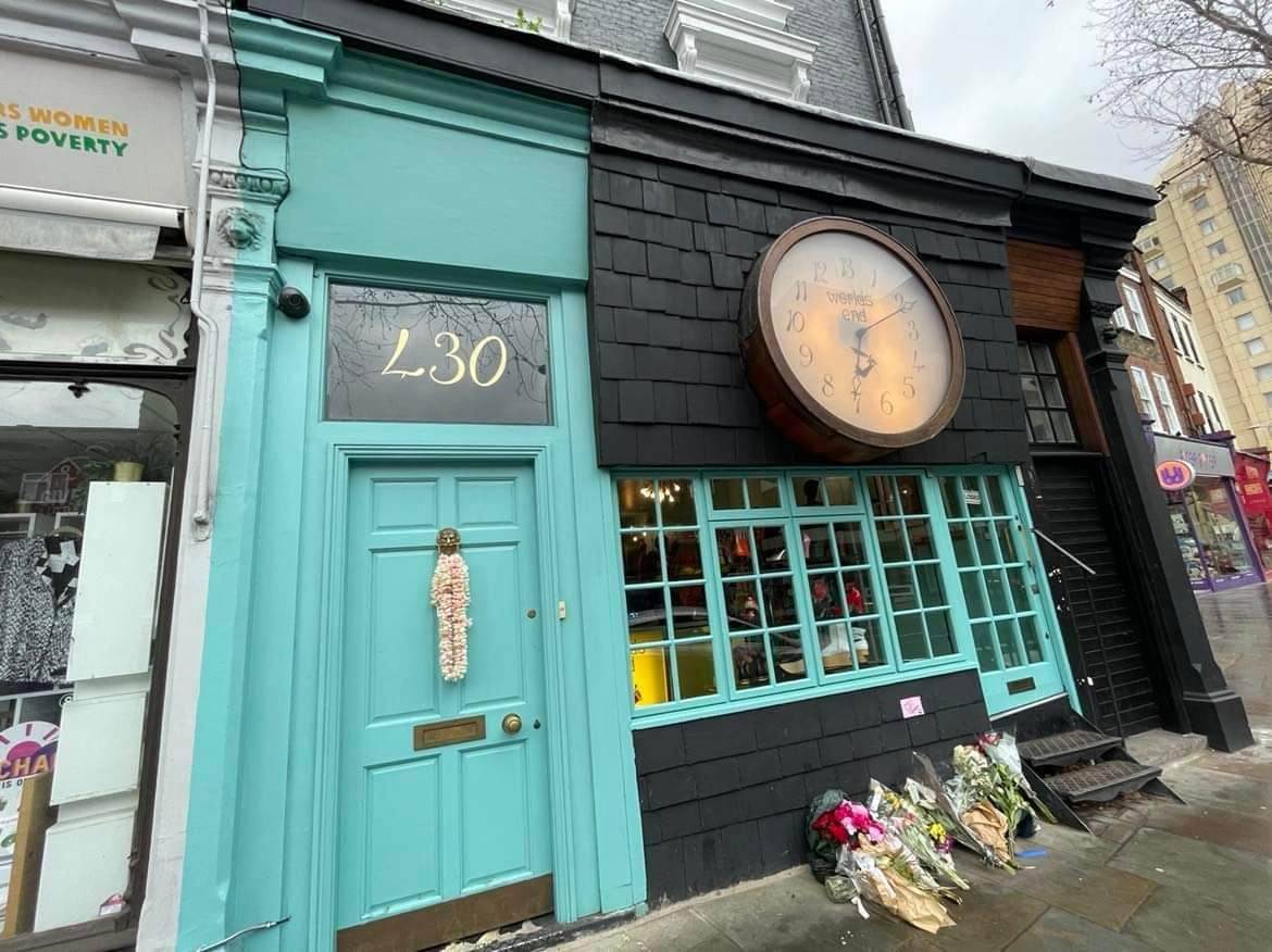EXTERIOR of  Westwood’s World’s End flagship store in London with flower offerings from fans following her death in 2022.