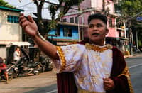 Residents of Barangay 154 in Tayuman, Manila, perform the Sinakulo along Perfecto Street on Holy Monday, March 30, 2026. The Sinakulo is a traditional Philippine dramatic performance that depicts the passion, death, and resurrection of Jesus Christ.