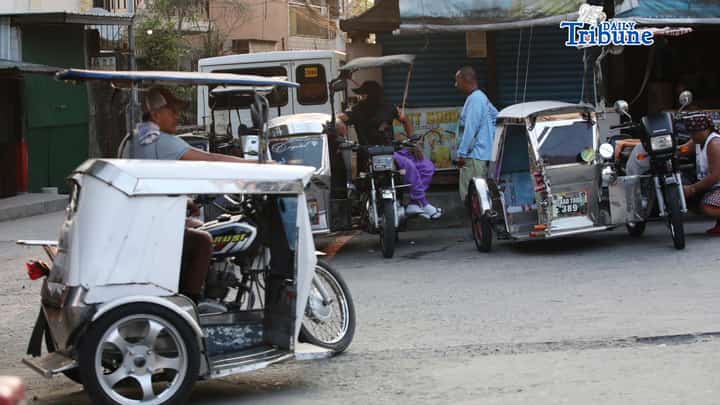 (March 31 2026) Tricycle drivers wait for passengers along a street in North Caloocan on Tuesday March 31 2026. About 30% of tricycle drivers from the CAATTODA in Caloocan City said that they did not receive the P5,000 cash aid for fuel from the government despite their list of names being submitted to the DSWD. Photo/Analy Labor