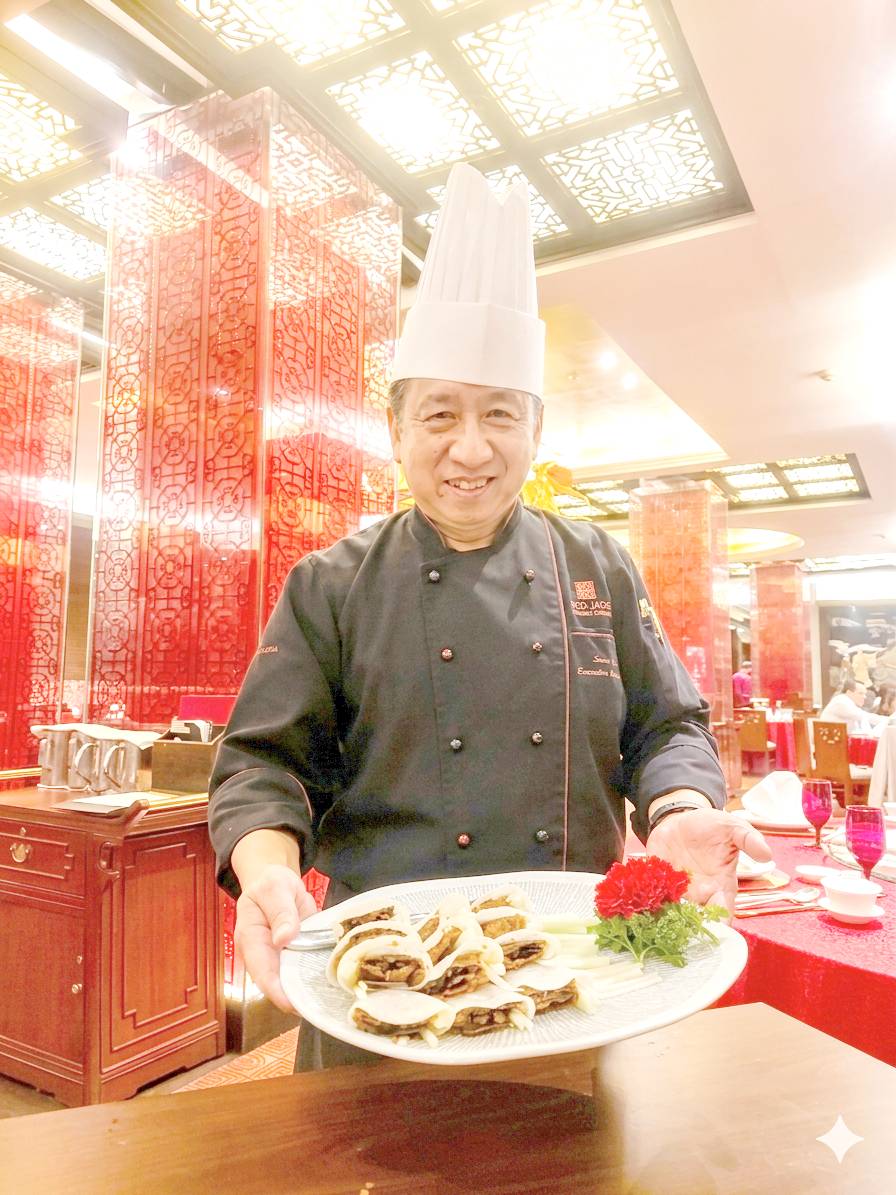 EXECUTIVE chef Sun Bing holding his original dish, the Vegetarian Peking Duck.