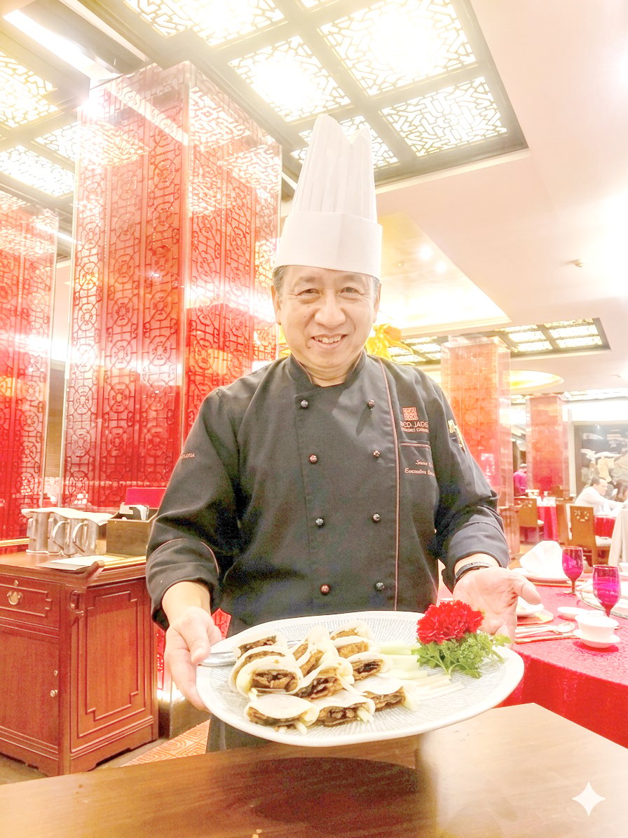 EXECUTIVE chef Sun Bing holding his original dish, the Vegetarian Peking Duck.