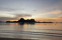 AT DUSK, El Nido exhales — light dissolving into a hush of sea and sky.