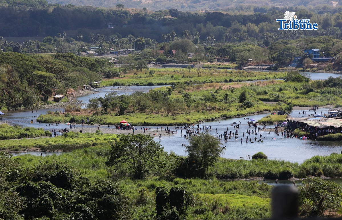 (April 03 2026)  Families enjoy swimming in the running waters of the Sta. Lucia River in Angat, Bulacan, on Good Friday April 3 2026. Photo/Analy Labor
