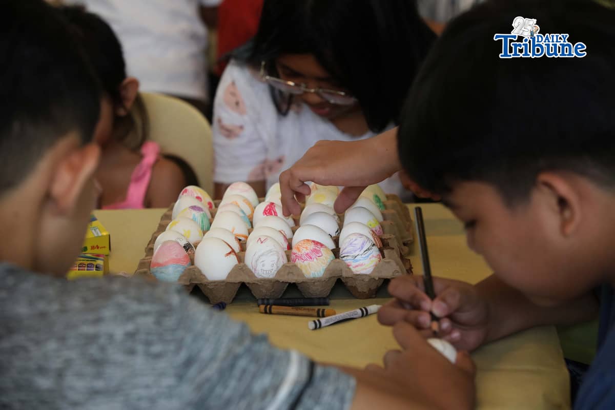 (April 04 2026) Kids accompanied by the adult volunteer painting the eggs at the Parish of the Holy Sacrifice at University of the Philippines Diliman Quezon City, on Black Saturday April 4 2026, as they prepare for their annual Easter Sunday celebrations of hunting eggs activities. Easter Sunday marks the core Christian belief in the Resurrection of Jesus Christ, celebrated as his rising from the dead three days after crucifixion. It signifies victory over sin, death, and darkness, offering hope, forgiveness, and eternal life. It ends the Lenten season of reflection, representing new life, renewal, and joy. Photo/Analy Labor