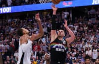 Nikola Jokic #15 of the Denver Nuggets scores against Victor Wembanyama #1 of the San Antonio Spurs in overtime at Ball Arena on April 4, 2026 in Denver, Colorado. NOTE TO USER: User expressly acknowledges and agrees that, by downloading and or using this photograph, User is consenting to the terms and conditions of the Getty Images License Agreement. The Nuggets won the game 136-134 in overtime.