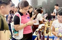 A DEPARTMENT of Trade and Industry representative checks products made from purple yam or ube during a recent product exposition. From New York coffee shops to Sydney bakeries, ube is taking the world by storm. Exports are booming.
