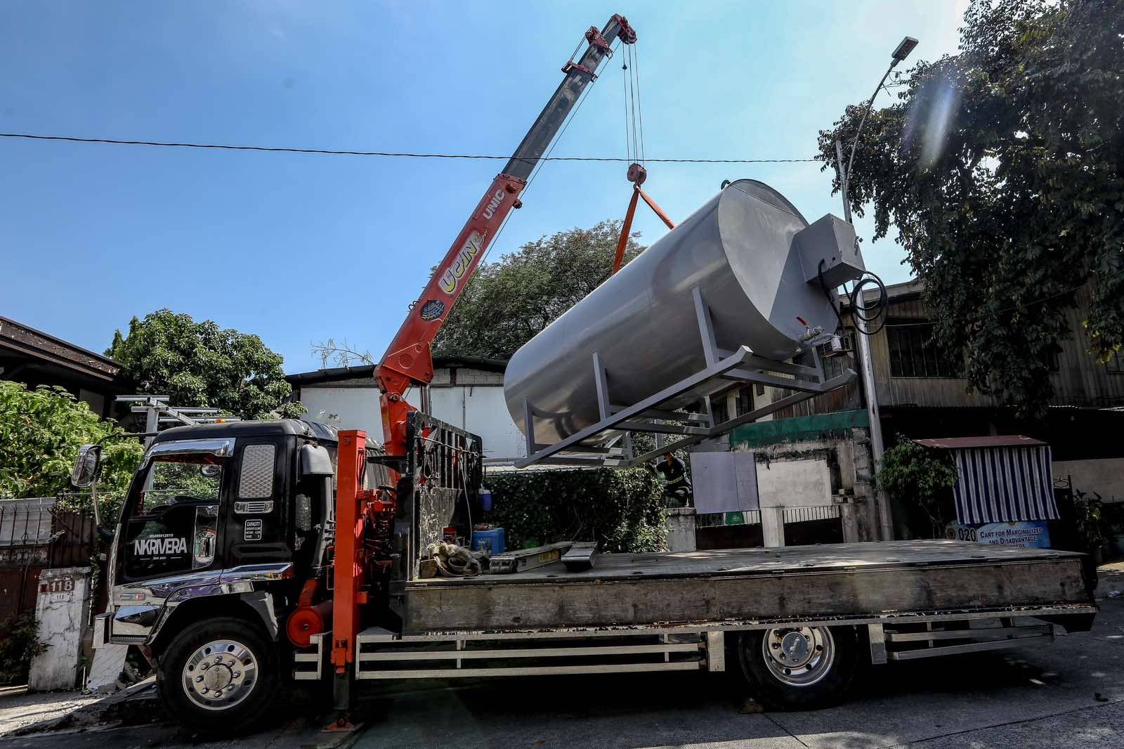 An oil tank containing 12,000 liters of diesel intended for fuel transfer is lifted in Barangay Sacred Heart, QuezonCity on 8 April 2026, as a businessman and a homeowner face possible economic sabotage charges over the alleged hoarding of fuel amid the ongoing crisis. | Aram Lascano