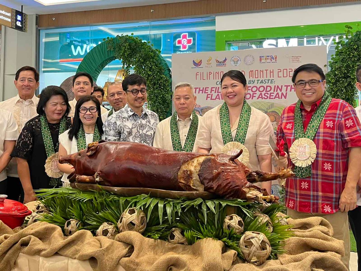 INSTEAD of a ribbon cutting, the Filipino Food Month mini fair at SM at Iloilo Terminal Market was opened with slicing a lechon led by (from left) Marichu Tellano, deputy executive director, National Commission for Culture and the Arts; Phoebe Zelie Areno, assistant director, Department of Tourism Region VI; Dennis Apria, regional director, Department of Agriculture Region VI; Eric B. Zerrudo, NCCA chairman and executive director; Iloilo City Mayor Raisa Treñas; Ivan Anthony Henares, secretary-general, UNESCO National Commission of the Philippines.